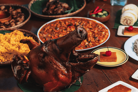 A vibrant table filled with various Filipino party dishes, including lumpia, adobo, and pancit, ready for celebration.