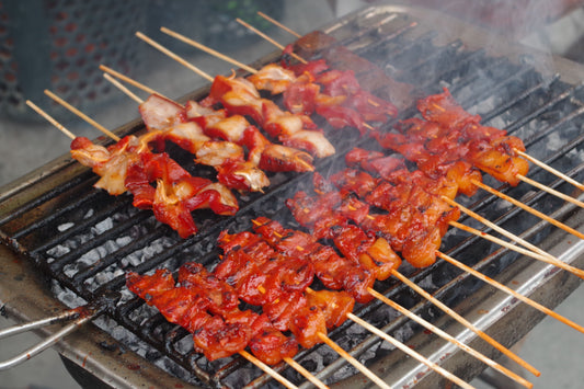 A barbecue grill filled with skewered meats, representing the delicious flavors of Filipino cuisine.