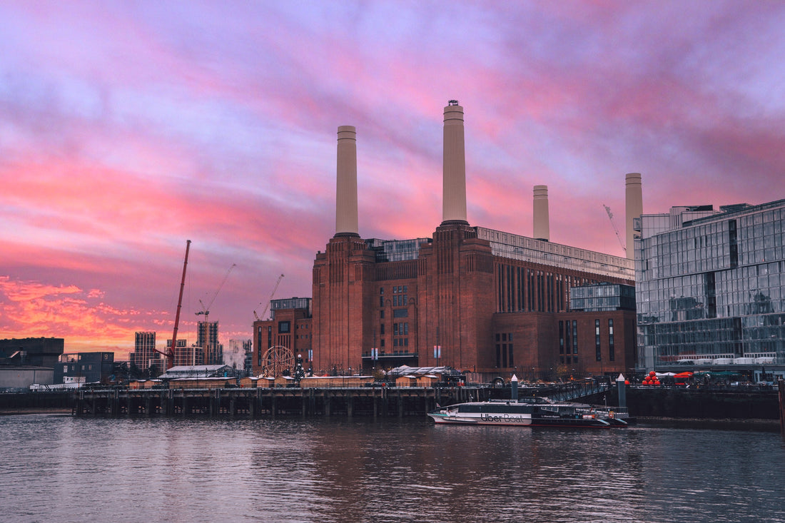 Soft clouds drift across a vibrant pink sky, capturing the tranquil beauty of Battersea, London.