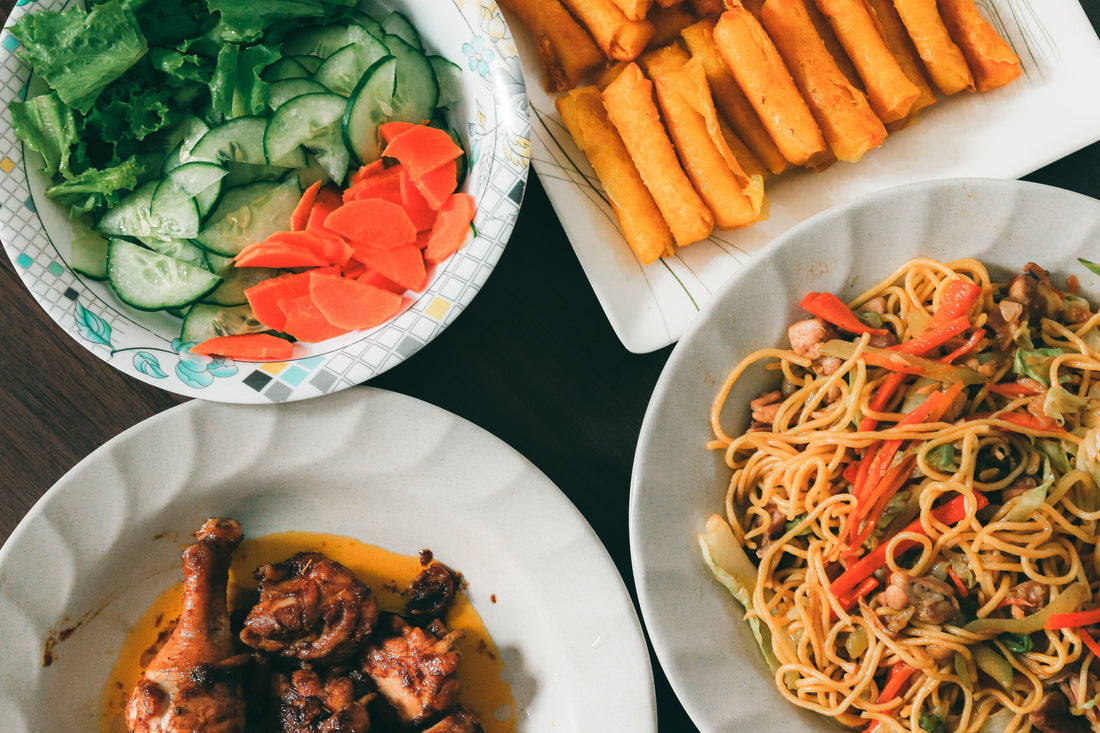 A table filled with various authentic Filipino dishes, showcasing vibrant colors and traditional presentation.