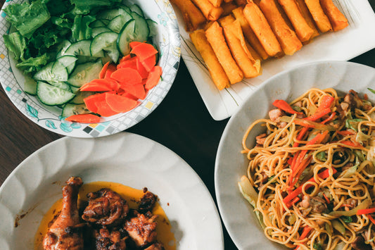 A table filled with various authentic Filipino dishes, showcasing vibrant colors and traditional presentation.