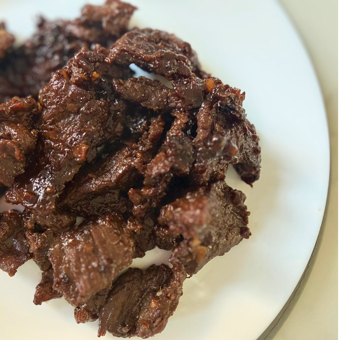 Plate of food with eggs, beef tapa and tomatoes 