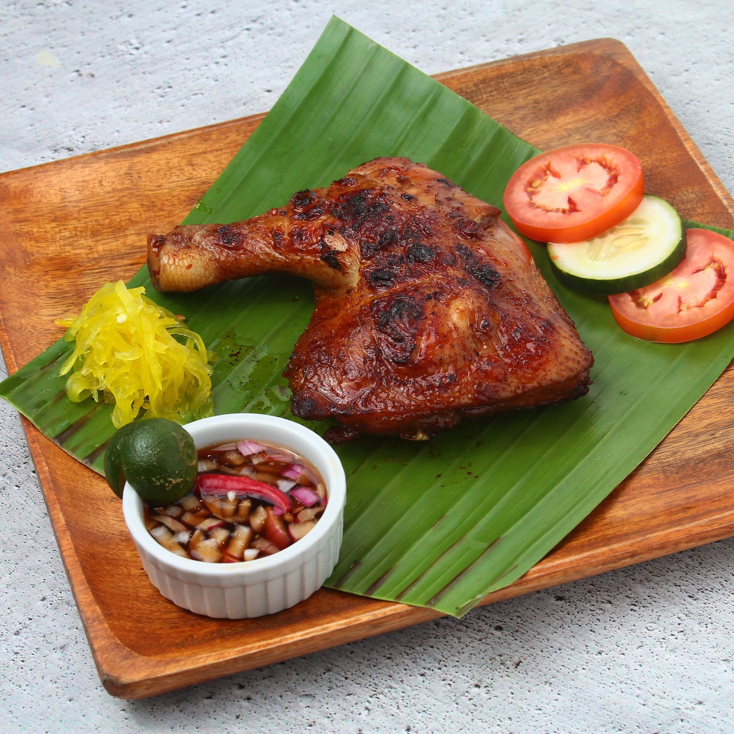 chicken inasal on a banana leaf
